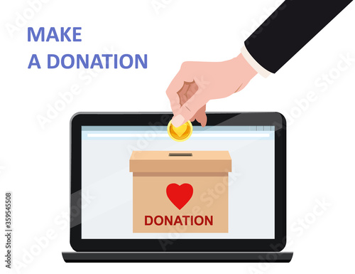 Donate online payments. Hand insert money gold coin in to the donation box on a laptop PC display