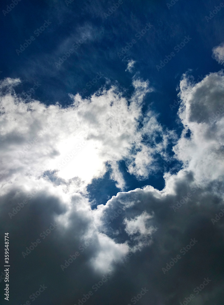 The sun breaks through the clouds of blue sky..Abstract scene. Natural background. Summer scenario. Outdoor landscape.