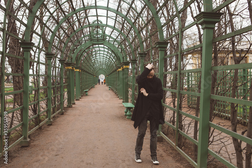 Man in the mantle in a city park