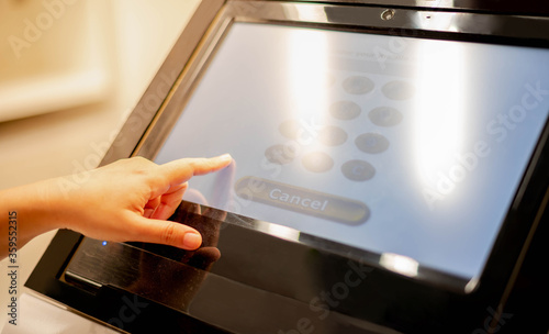 Female hand touching the tablet monitor in side the public area for the get the information or description of product to customer