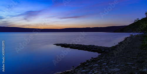 nature panorama evening dusk time lake reservoir shore line and phantom blue lighting scenery calm and peaceful nature environment