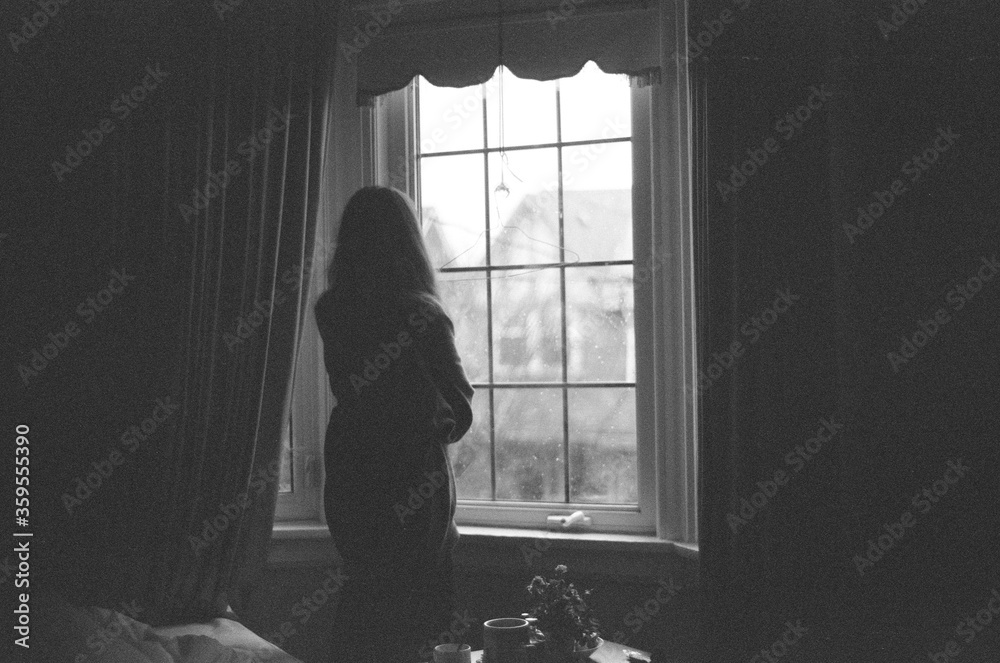woman looking out the window