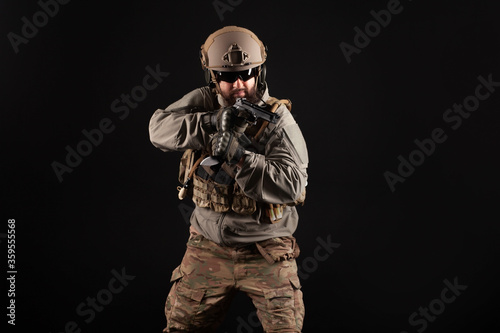 military special forces in uniform with weapons attack at night, elite troops, counter-terrorist against a dark background