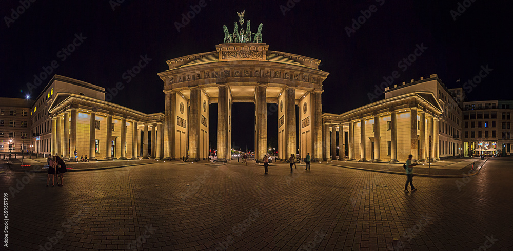 Night view over Paris square to illuminated Brandenburger gate in Berlin in summer