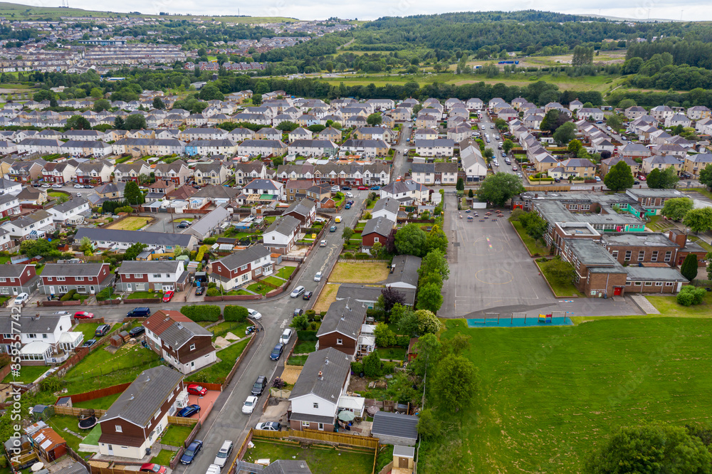 Aerial drone view of a residential area of a small Welsh town surrounded by hills (Ebbw Vale, South Wales, UK)