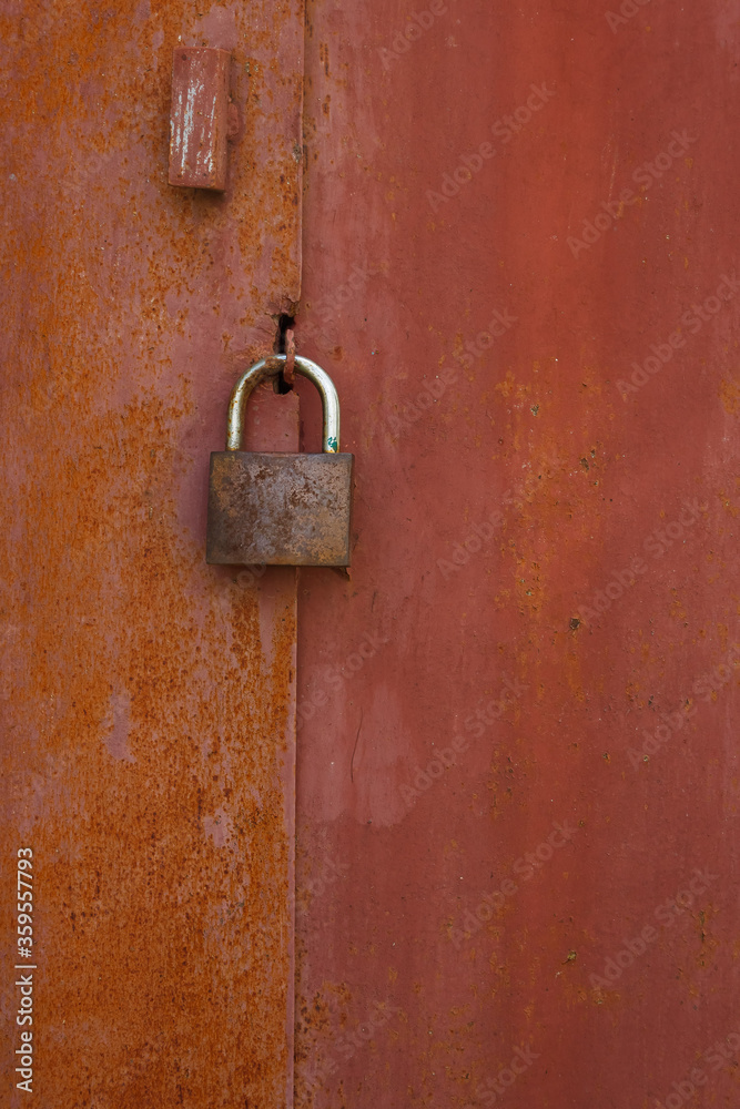 Old rusty lock on a metal garage door Old rusty lock on a metal garage door