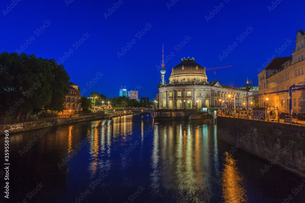 View from Ebert bridge in Berlin over river Spree and Bode museum to television tower in evening twillight in summer