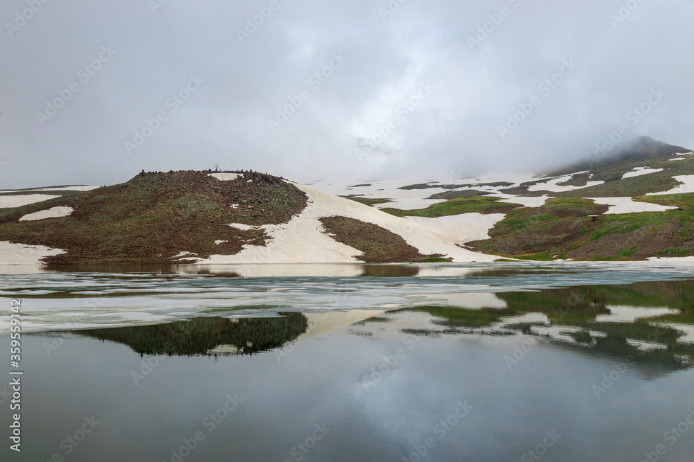 Picturesque Alpine Lake Kari in the mountains of Armenia in summer Picturesque Alpine Lake Kari in the mountains of Armenia in summer