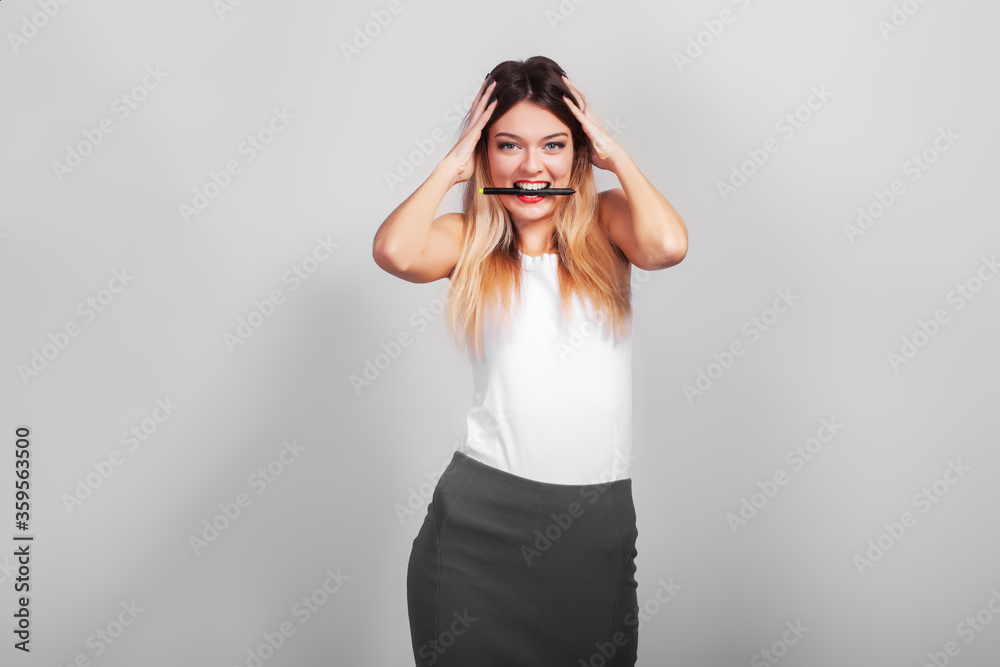 Business Woman drawing with pen on virtual screen with copy space for text on gray background Business Woman drawing with pen on virtual screen with copy space for text on gray background