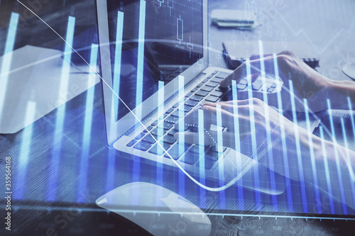 Double exposure of woman hands typing on computer and forex chart hologram drawing. Stock market invest concept.