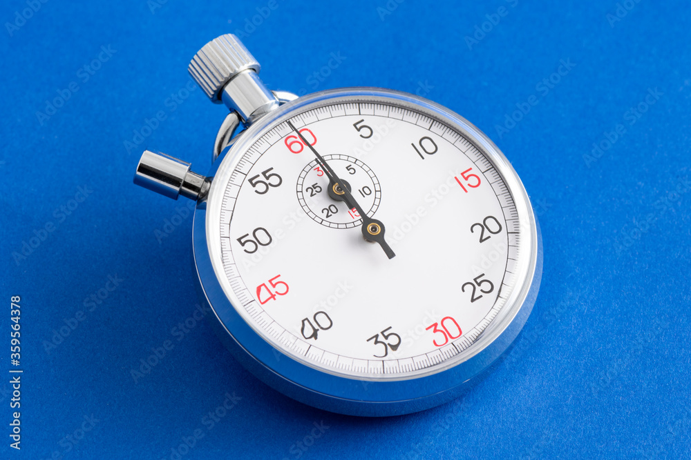 Analogue metal stopwatch on the blue background. Analogue metal stopwatch on the blue background.