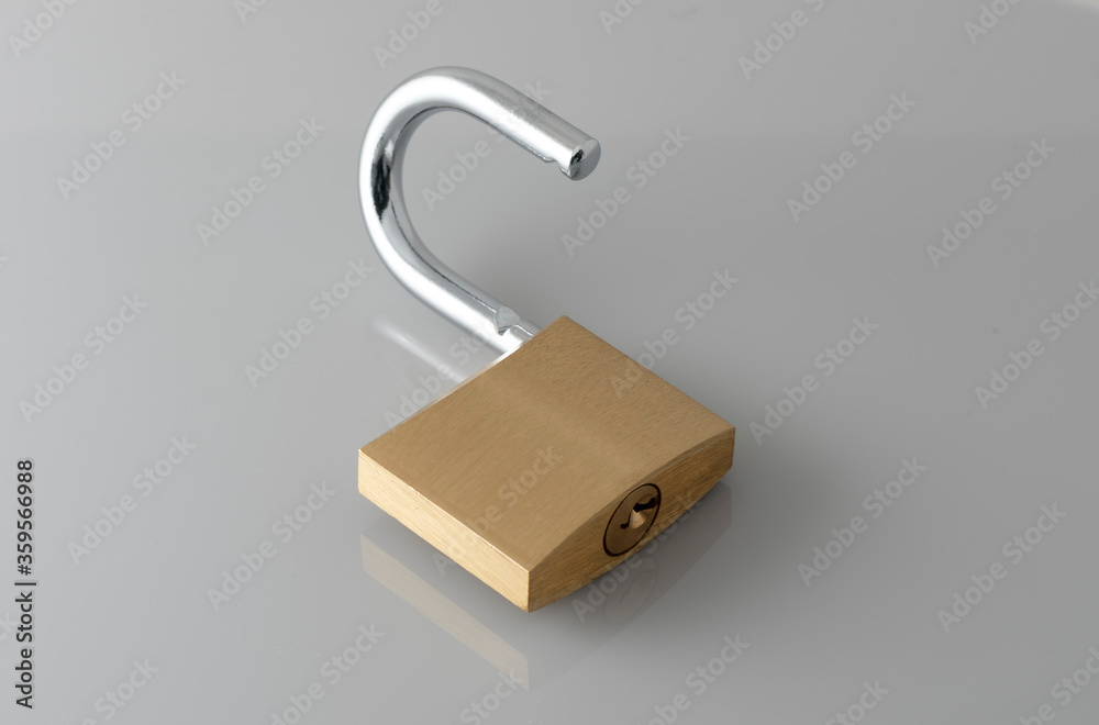 Unlocked Golden Padlock on the gray background. Unlocked Golden Padlock on the gray background.