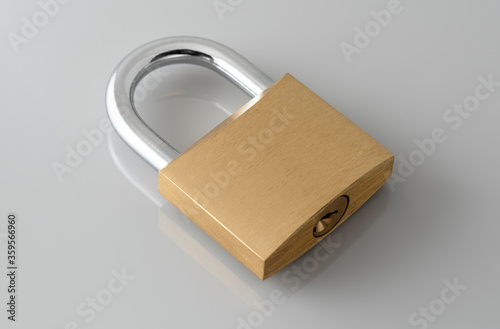 Locked Golden Padlock on the gray background.
