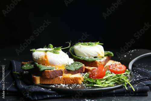 Delicious poached egg sandwiches served on slate board