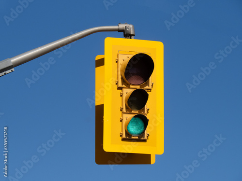 a traffic signal light with the green light lit