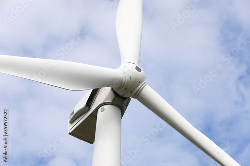 Wind turbine against beautiful sky, closeup. Alternative energy source