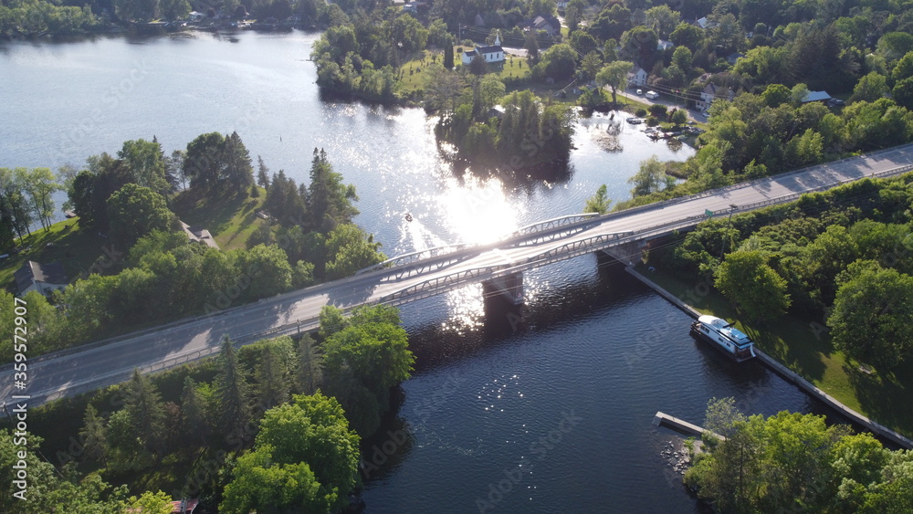Aerial Image of a bridge above a river during bright summer day