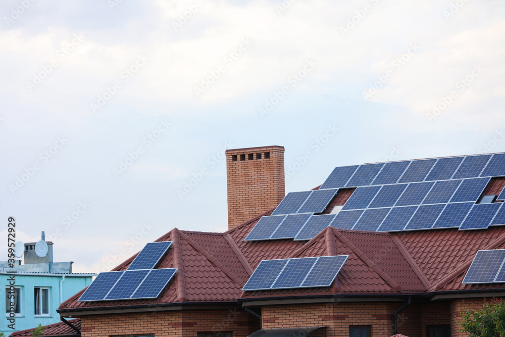 House with installed solar panels on roof House with installed solar panels on roof