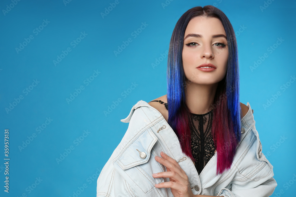 Young woman with bright dyed hair on blue background, space for text Young woman with bright dyed hair on blue background, space for text
