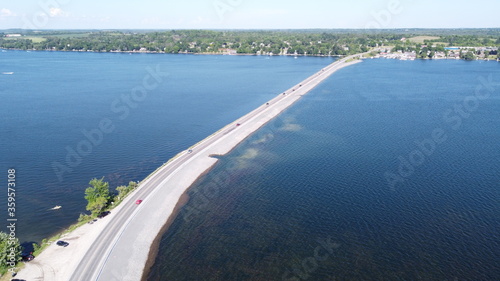Image of Highway road spanning through lake during clear summer weather © Ernest