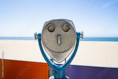 colorful viewfinder at beach with blue skies, sand, and colorful wall