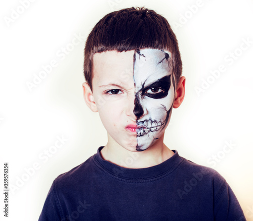 little cute boy with facepaint like skeleton to celebrate halloween, lifestyle people concept, children on holiday