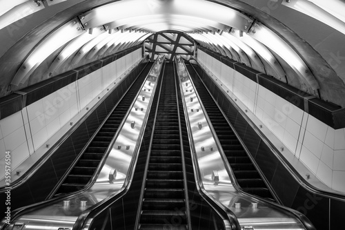 Times square subway escalator in black and white.