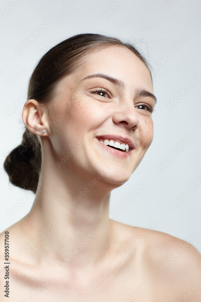 Headshot of emotional female face portrait with serene facial expression. Headshot of emotional female face portrait with serene facial expression.
