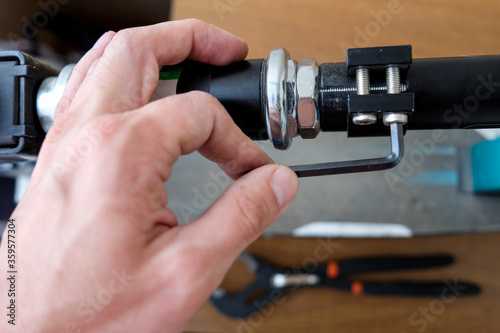 loosening the screw with a hex wrench. repair of household items at home