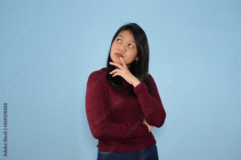 Portrait of Indonesian Woman Wearing Red Shirt And Posing With Isolated Background Portrait of Indonesian Woman Wearing Red Shirt And Posing With Isolated Background