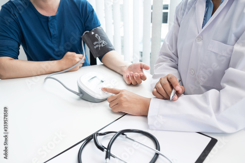 The doctor is consulting about treatment plan with patient in the hospital.