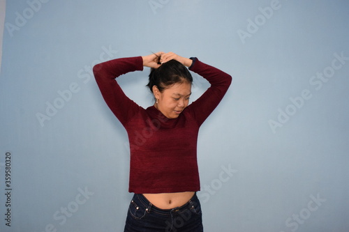 Portrait of Indonesian Woman Wearing Red Shirt And Posing With Isolated Background © Sino Images Studio