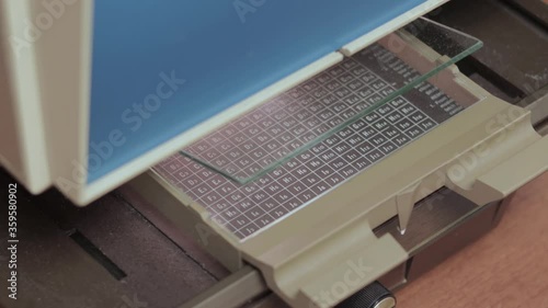 Man using microfiche reader to research archived documents