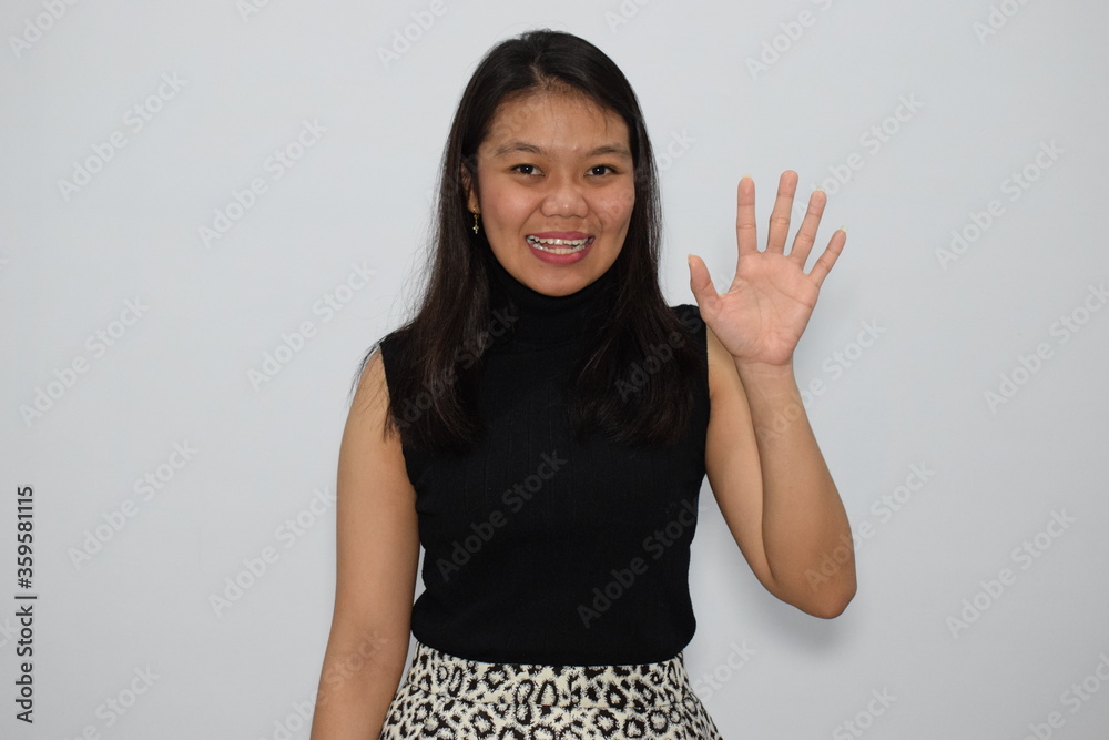 Portrait of Indonesian Woman Wearing Black Shirt And Posing With Isolated Background Portrait of Indonesian Woman Wearing Black Shirt And Posing With Isolated Background