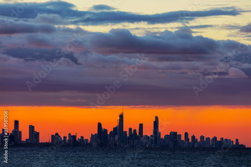 A large mass of stratus clouds hovering over Surfers Paradise cityscape at sunset
