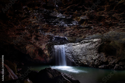 Water flowing down the Natural Bridge in Springbrook  view under the cave. Gold Coast hinterland