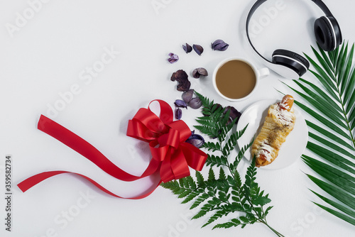 Top view of fresh bread and coffee,Fern leaf,monstera leaf, separate on a white background wood