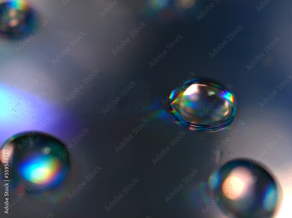 blurred water droplets with blue light on black backgronud, dark and shiny , abstract background, macro image for card design blurred water droplets with blue light on black backgronud, dark and shiny , abstract background, macro image for card design