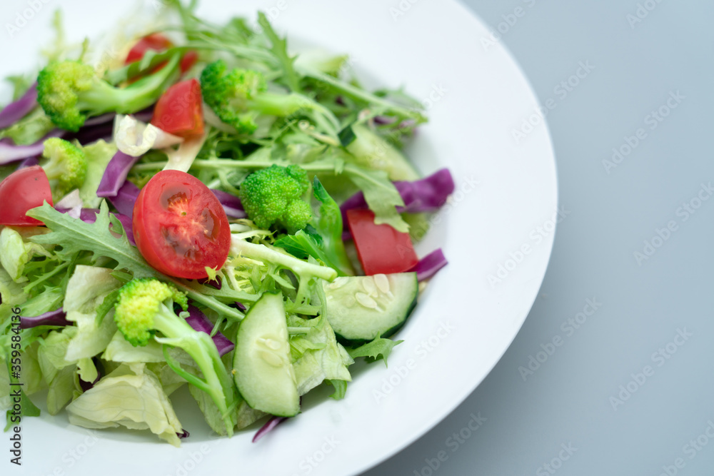 Close-up of a plate of delicious healthy green vegetable salad.