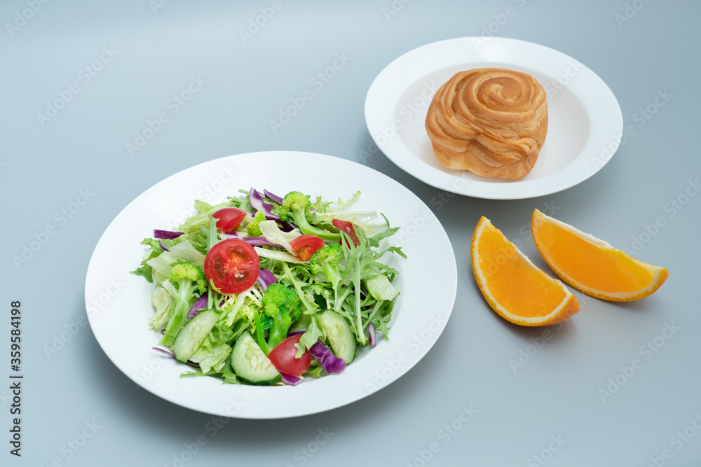 A plate of healthy and delicious salad and a bread