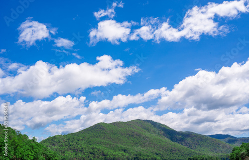 Clouds over mountains with cleary weather.