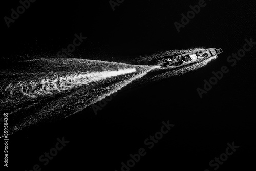 Black and white background of ship sails on river.