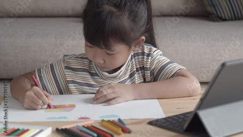Education. Asian little girl learning and drawing with online teacher on tablet 