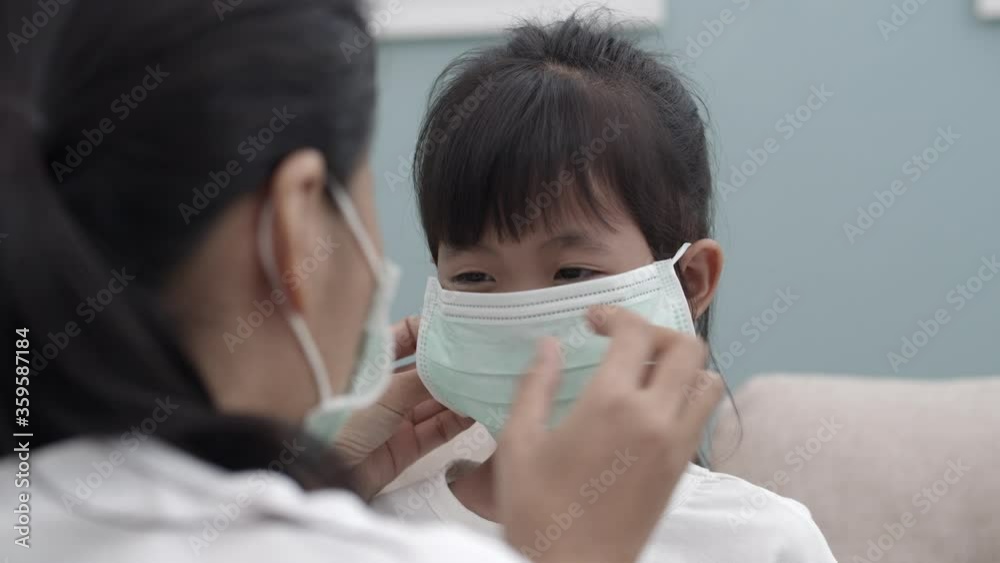 Asian family with mother wear mask daughter her close-up Asian family with mother wear mask daughter her close-up