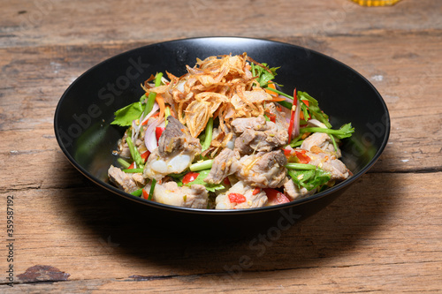 Fried Pork Spare Ribs With Garlic And Pepper Mix With Spicy Salad In Bowl