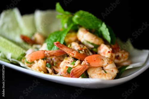 Thai food - spicy Shrimp salad with garlic and basil
