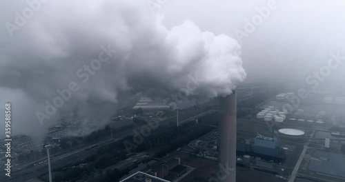 aerial through smoke out of chimney of a coal power plant at Hemweg at port Amsterdam photo