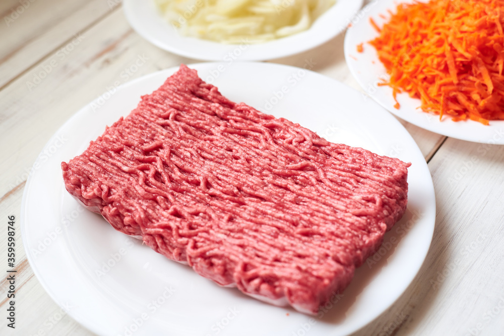Raw minced meat on a wooden background. Raw minced meat on a wooden background.