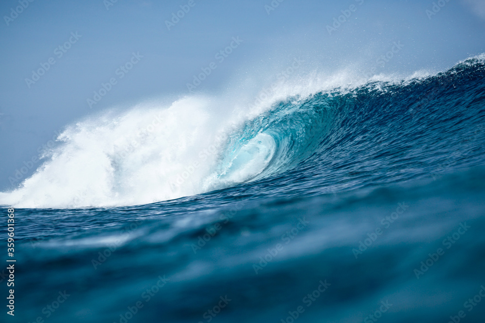 Perfect blue aquamarine wave, empty line up, perfect for surfing, clean water, Indian Ocean close to Maldivian island Thulusdhoo Perfect blue aquamarine wave, empty line up, perfect for surfing, clean water, Indian Ocean close to Maldivian island Thulusdhoo