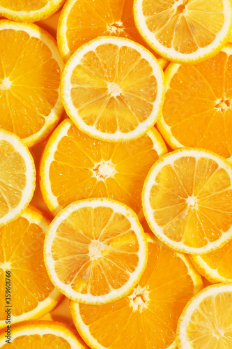 Top view of tasty slices of orange and lemon. Bright summer background. Healthy food. Proper nutrition. Fresh juices. Copy space, flat lay. Backdrop texture of fruits. Citrus products concept